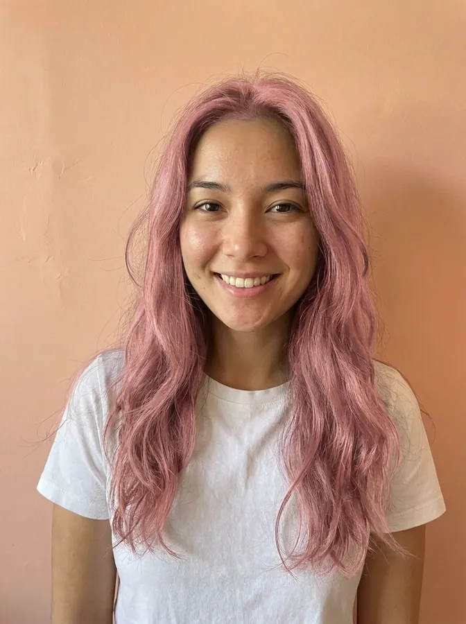 The same woman with pastel pink hair in the same length and waves